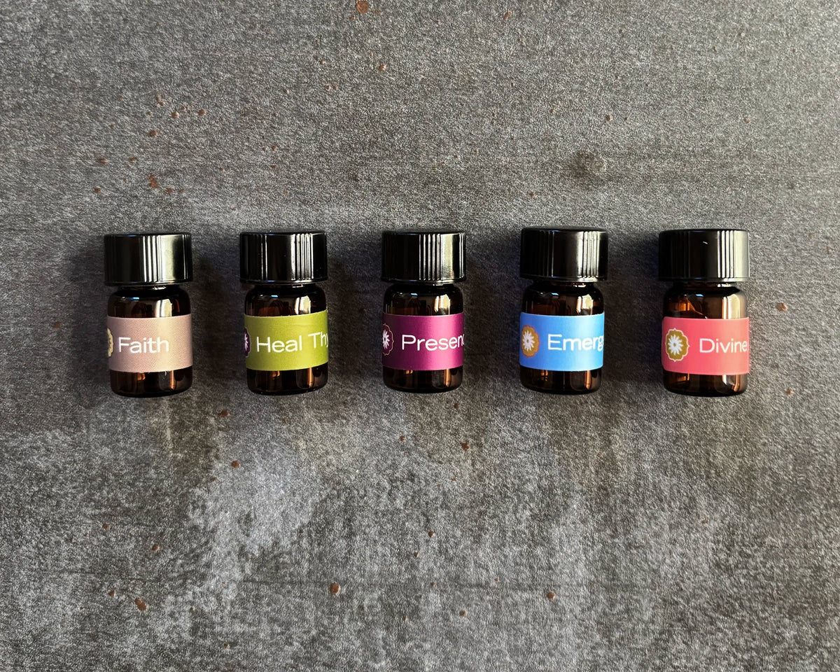 A collection of small amber vials featuring five BodyMantra oil blends