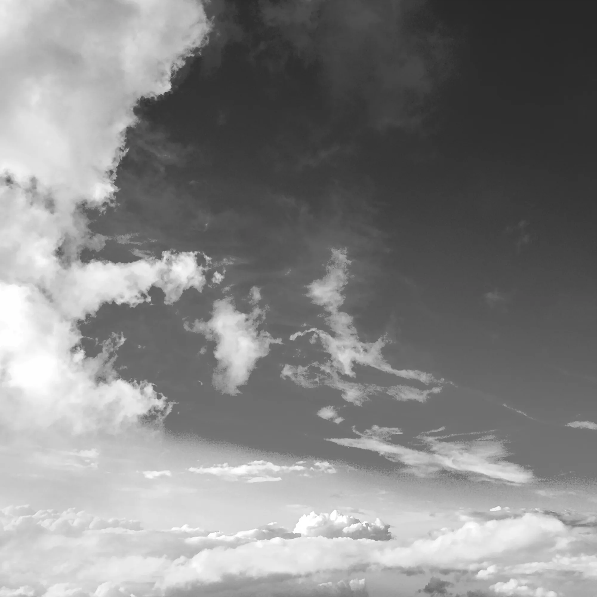 High altitude brightly-lit wispy clouds